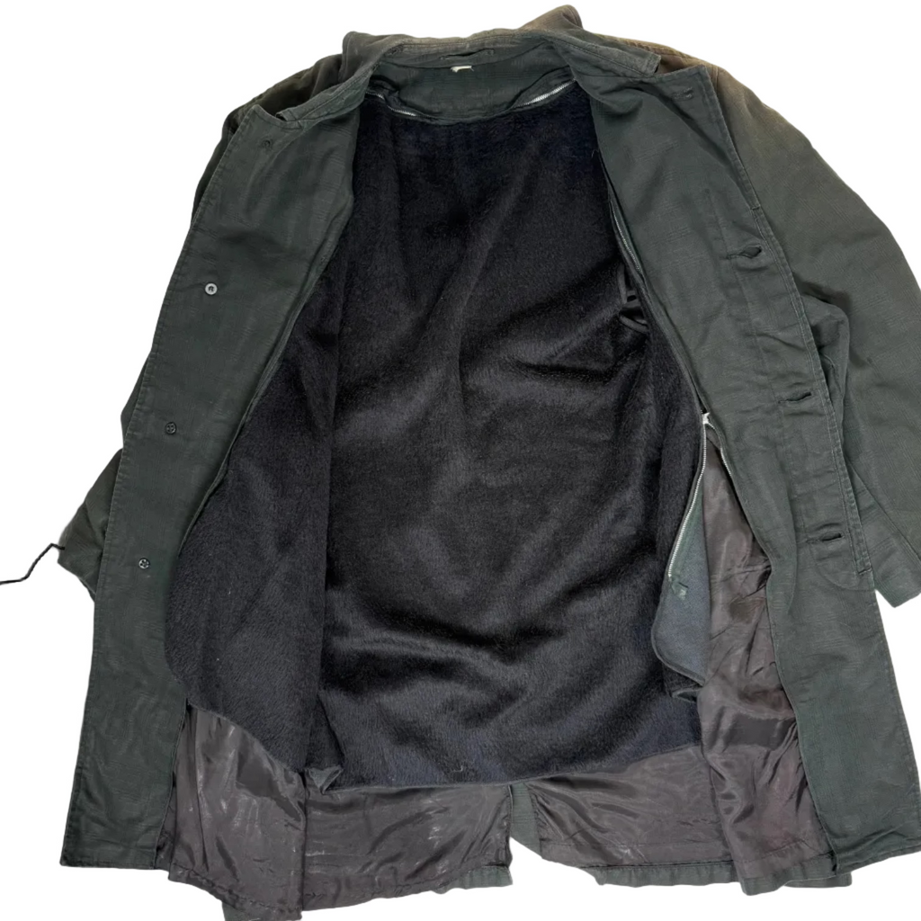 Green jacket with black lining on a white background